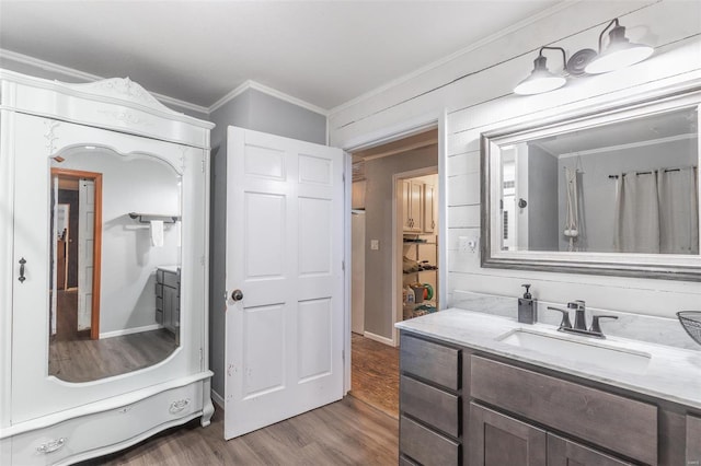 bathroom featuring hardwood / wood-style floors, vanity, and crown molding