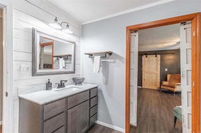 bathroom featuring hardwood / wood-style floors, vanity, and crown molding