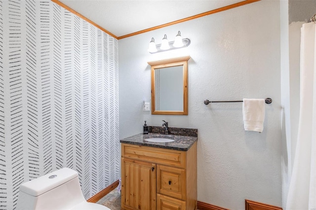 bathroom featuring toilet, vanity, and crown molding