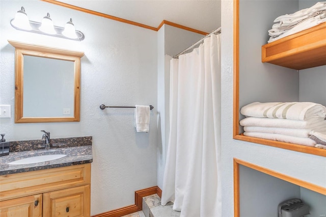 bathroom featuring vanity, ornamental molding, and curtained shower