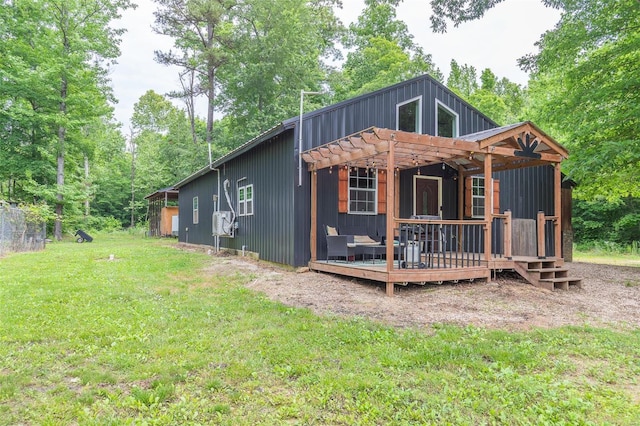 rear view of house featuring a deck, cooling unit, a yard, and a pergola