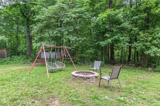 view of yard featuring an outdoor fire pit and a playground