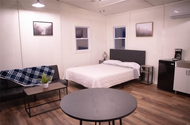 bedroom featuring hardwood / wood-style floors, lofted ceiling, and a wall mounted AC