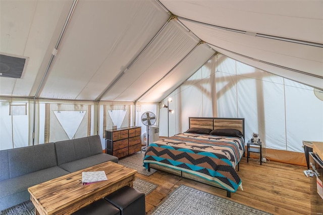 bedroom featuring hardwood / wood-style floors and vaulted ceiling