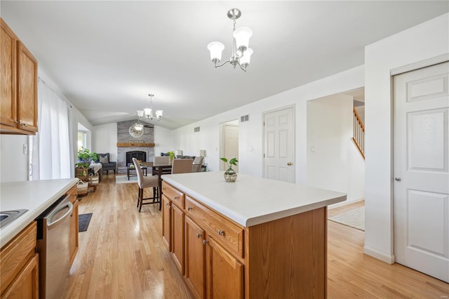 kitchen featuring a center island, hanging light fixtures, a notable chandelier, light wood-type flooring, and stainless steel dishwasher