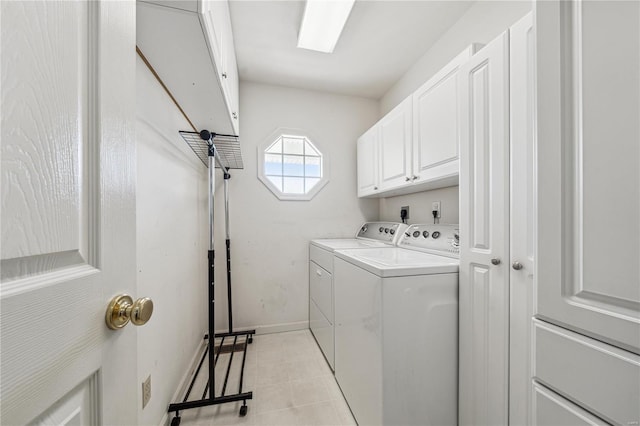 washroom with independent washer and dryer and cabinets