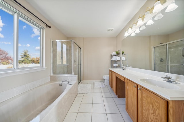 full bathroom with separate shower and tub, toilet, tile patterned flooring, and a wealth of natural light