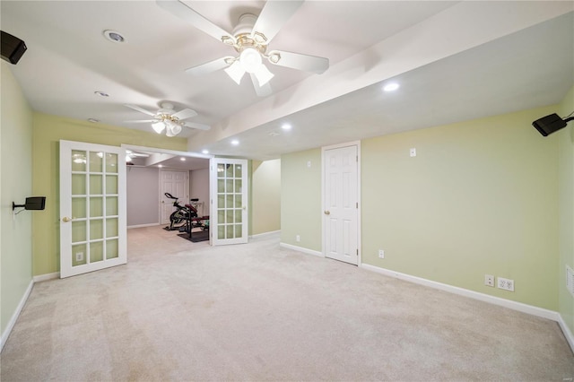 unfurnished room featuring ceiling fan, light colored carpet, and french doors