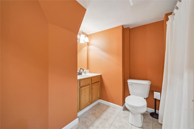 bathroom with toilet, tile patterned floors, and vanity