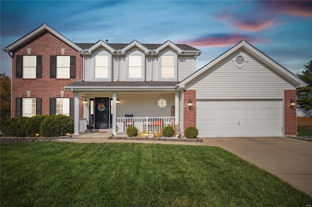 view of front facade featuring a garage, a yard, and a porch