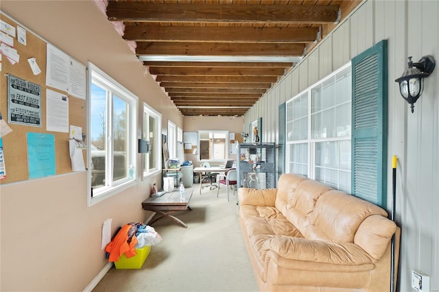 sunroom featuring beam ceiling