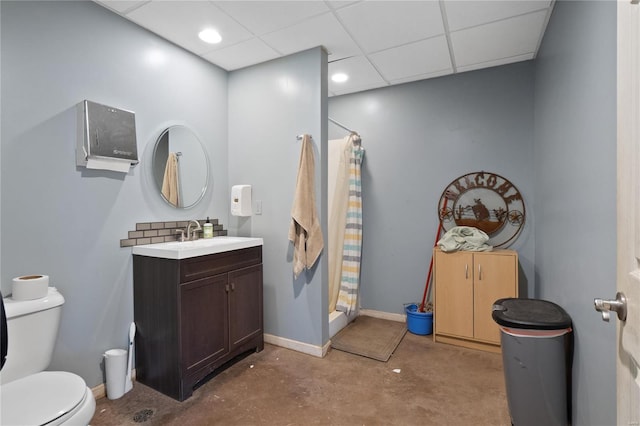 bathroom with concrete flooring, a paneled ceiling, vanity, toilet, and a shower with shower curtain