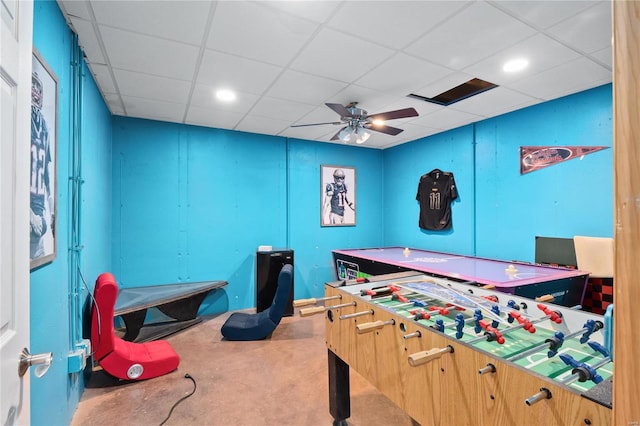 game room with a drop ceiling and ceiling fan