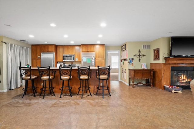 kitchen featuring appliances with stainless steel finishes and a breakfast bar area