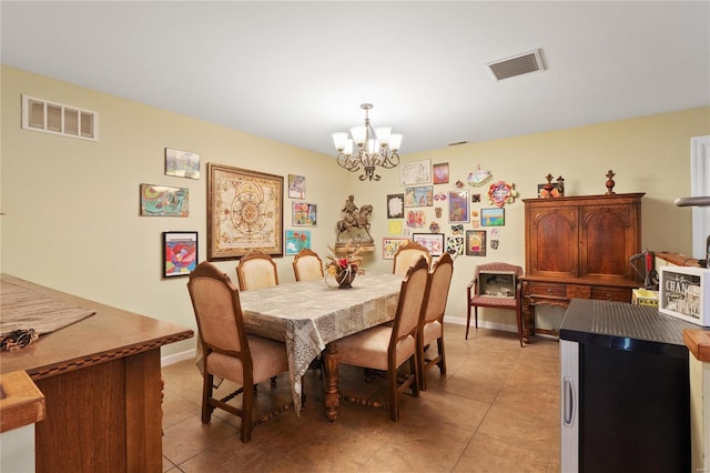 tiled dining room with a notable chandelier