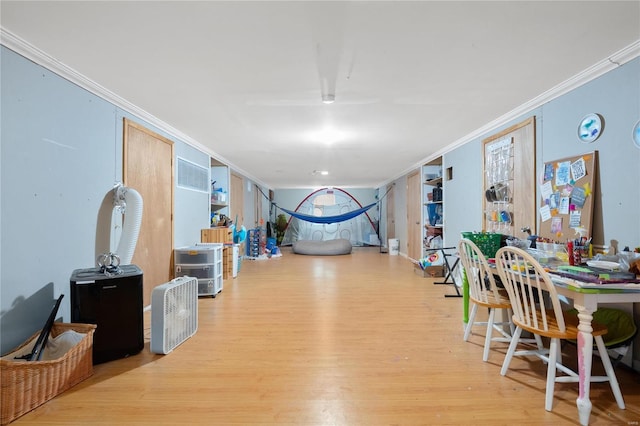 interior space with ornamental molding and light wood-type flooring