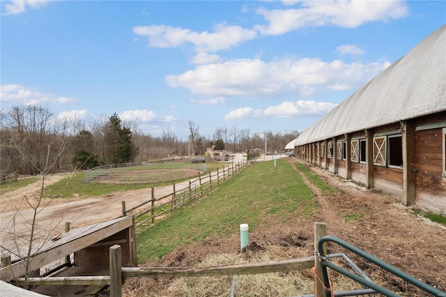 view of yard with a rural view and an outdoor structure