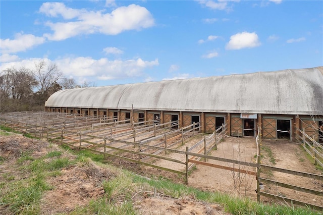 view of horse barn with a rural view