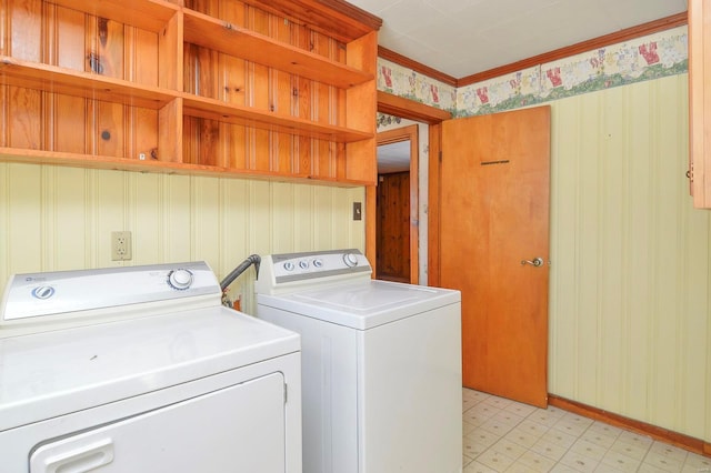 washroom with crown molding and washing machine and clothes dryer