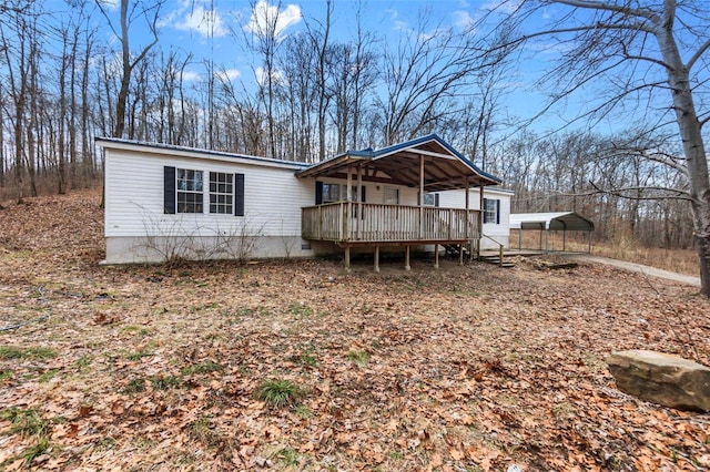 view of front of home with a carport and a wooden deck