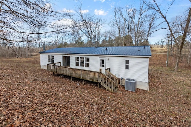 rear view of house with cooling unit and a deck