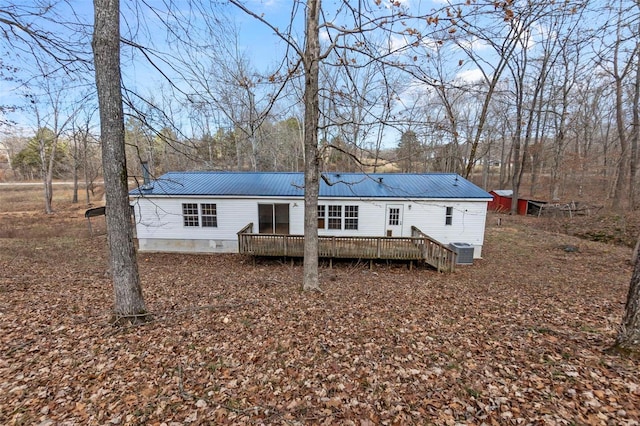 back of house featuring a wooden deck and central air condition unit