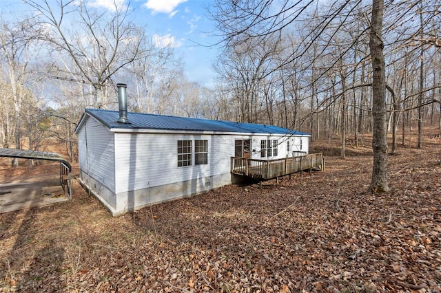 back of house featuring a wooden deck