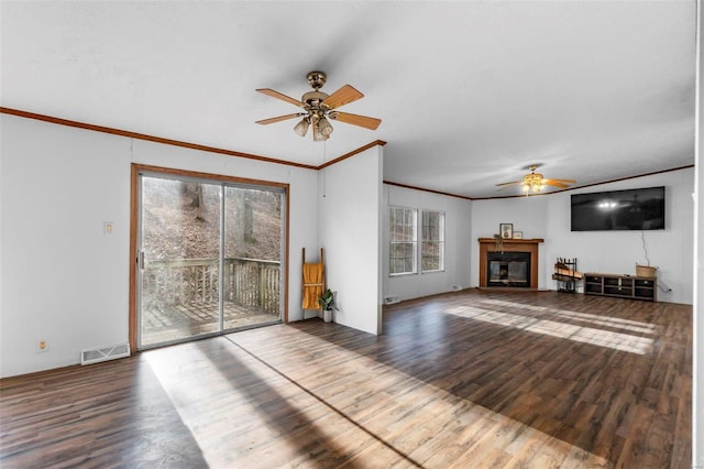 unfurnished living room with wood-type flooring, ornamental molding, and ceiling fan