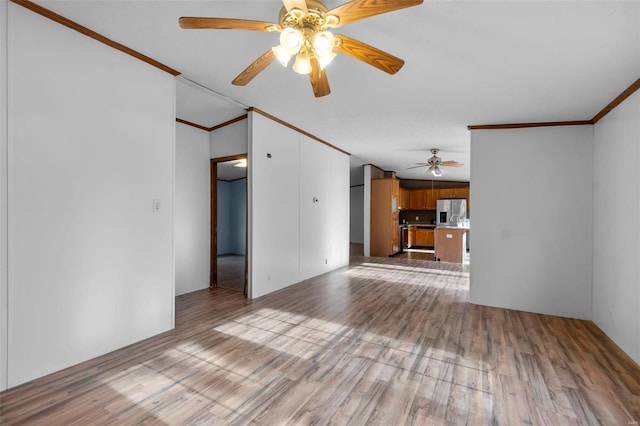 unfurnished living room with ornamental molding, ceiling fan, and light hardwood / wood-style floors