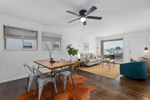 dining space featuring dark wood-type flooring and ceiling fan