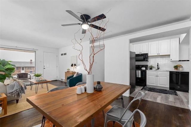 dining room featuring ceiling fan, dark hardwood / wood-style flooring, and sink