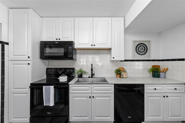 kitchen with backsplash, white cabinets, sink, and black appliances