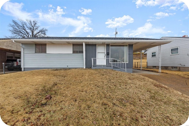 view of front of home with a front lawn and a carport