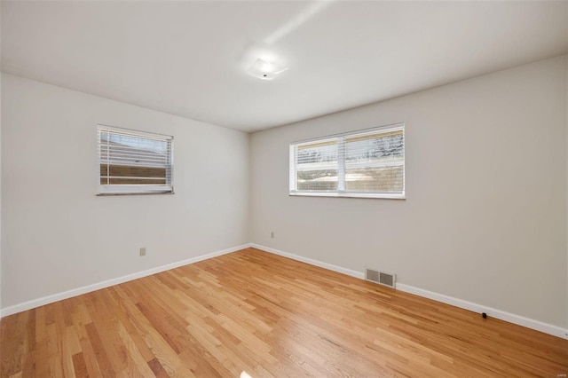 spare room with light hardwood / wood-style floors