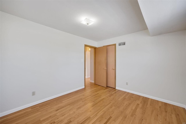 unfurnished room with light wood-type flooring