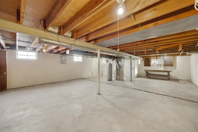 basement featuring water heater and electric panel