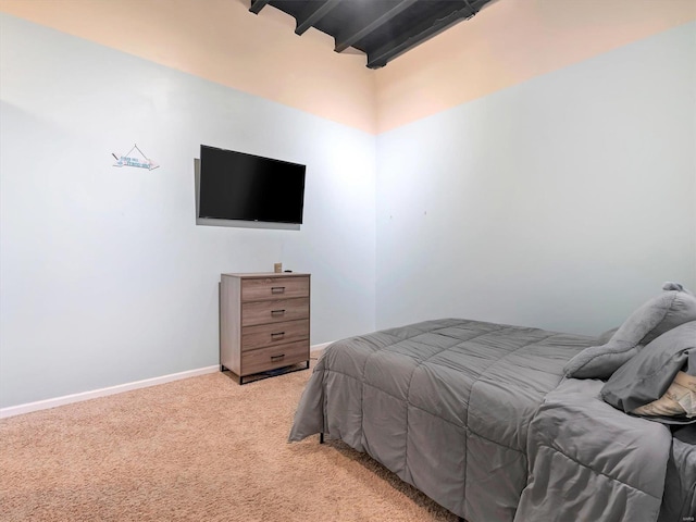 carpeted bedroom featuring beamed ceiling