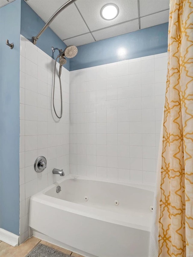 bathroom with shower / tub combo, a paneled ceiling, and tile patterned floors