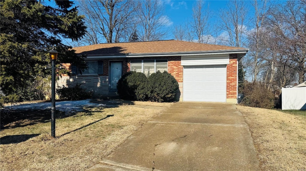 single story home with a garage and a front yard