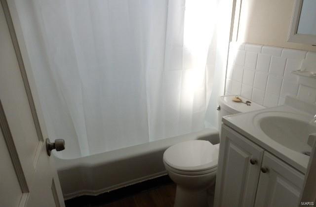 full bathroom with toilet, shower / tub combo, and vanity