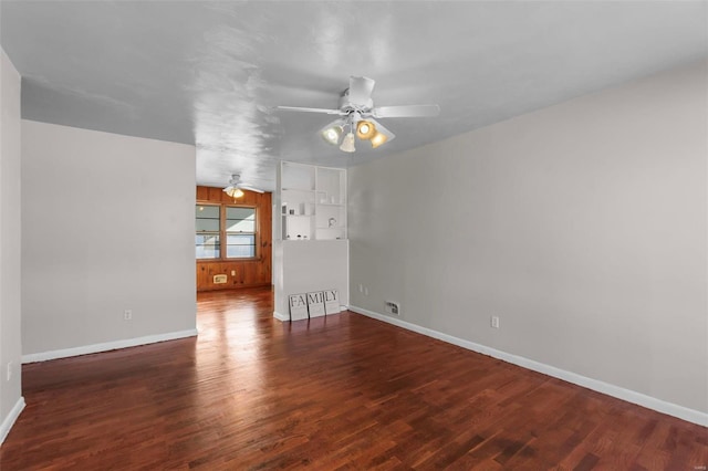 spare room featuring ceiling fan and dark hardwood / wood-style floors