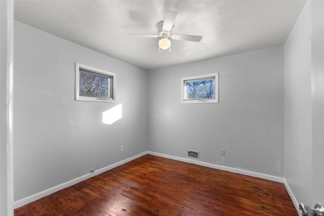 empty room featuring ceiling fan and dark hardwood / wood-style flooring