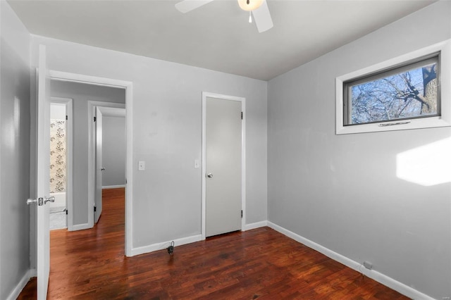 unfurnished bedroom with dark hardwood / wood-style floors and ceiling fan