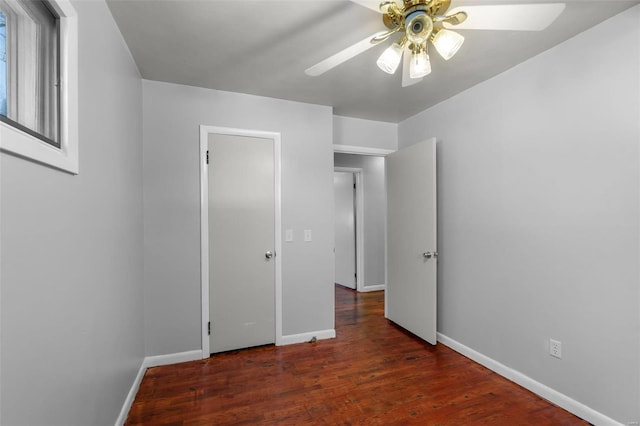 unfurnished bedroom with ceiling fan and dark hardwood / wood-style floors