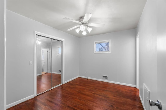 unfurnished bedroom with a closet, ceiling fan, and dark hardwood / wood-style flooring