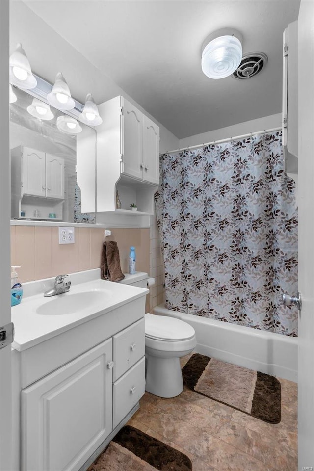 full bathroom with shower / bath combo with shower curtain, decorative backsplash, toilet, and vanity