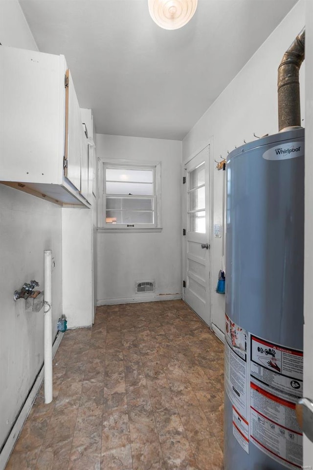 utility room with water heater