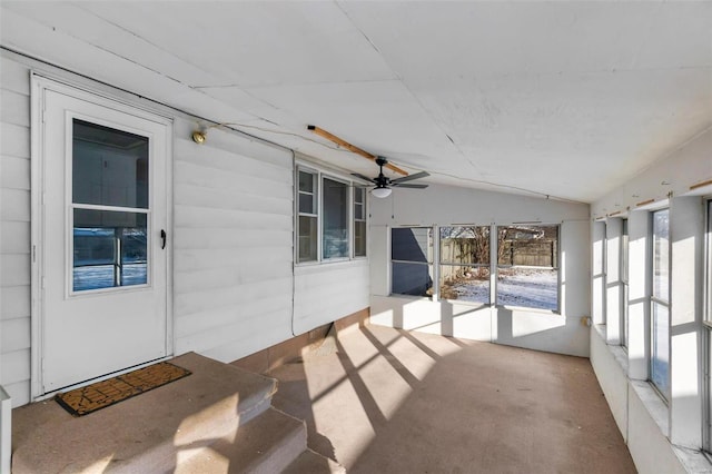 unfurnished sunroom featuring vaulted ceiling