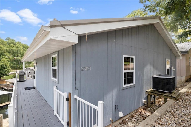 view of property exterior featuring a wooden deck and cooling unit