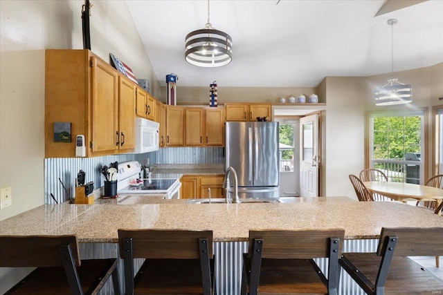 kitchen with range, stainless steel fridge, an inviting chandelier, and decorative light fixtures